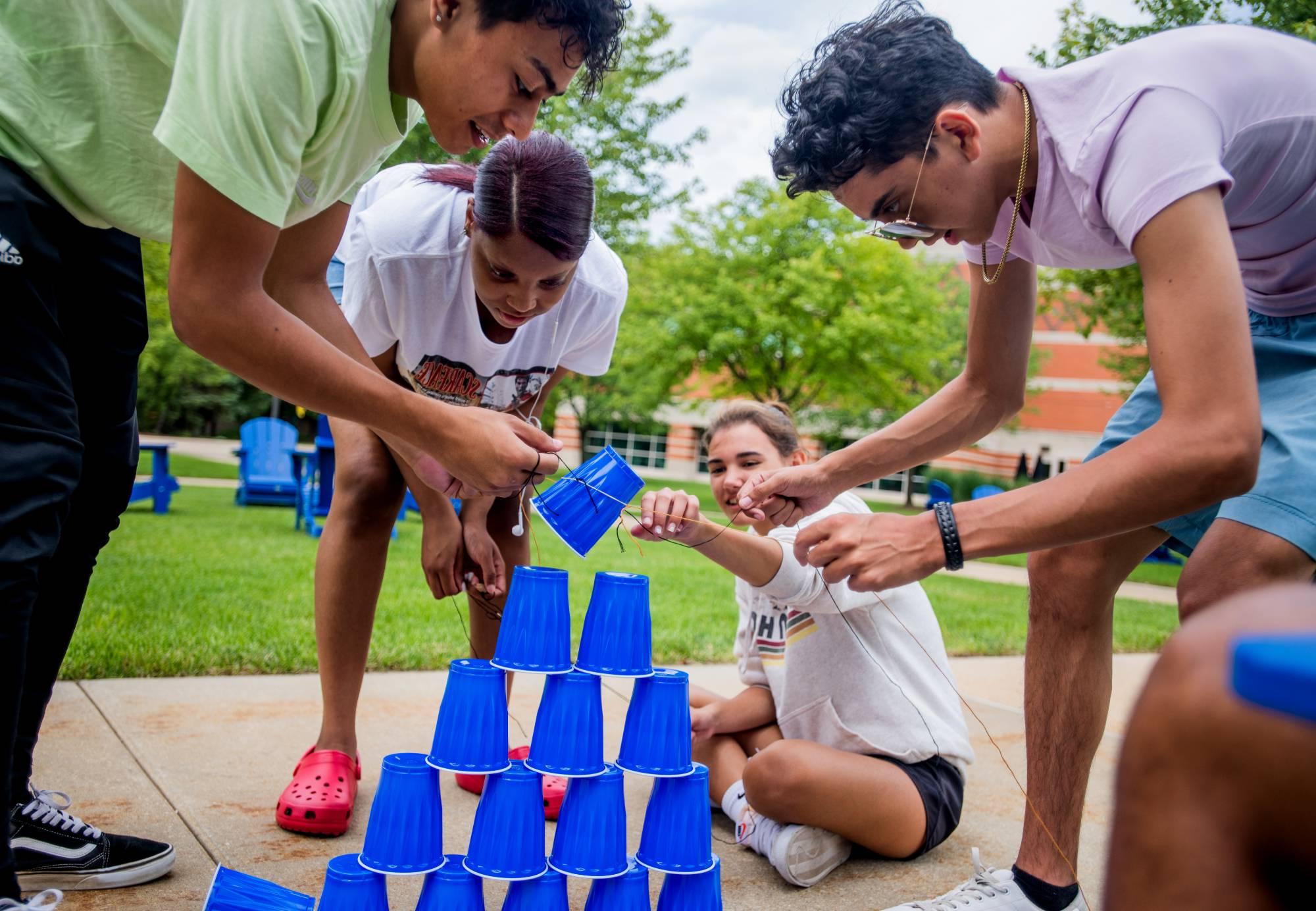 Students stacking cups as a a group